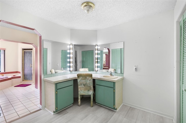 34 Misty Meadow Ln, Mulberry, FL 33860 - bathroom featuring a garden tub, a textured ceiling, vanity, wood finished floors, and a stall shower