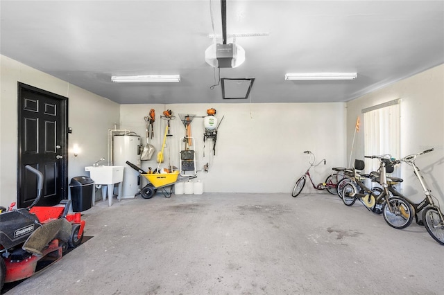 34 Misty Meadow Ln, Mulberry, FL 33860 - garage featuring water heater, a garage door opener, and a sink