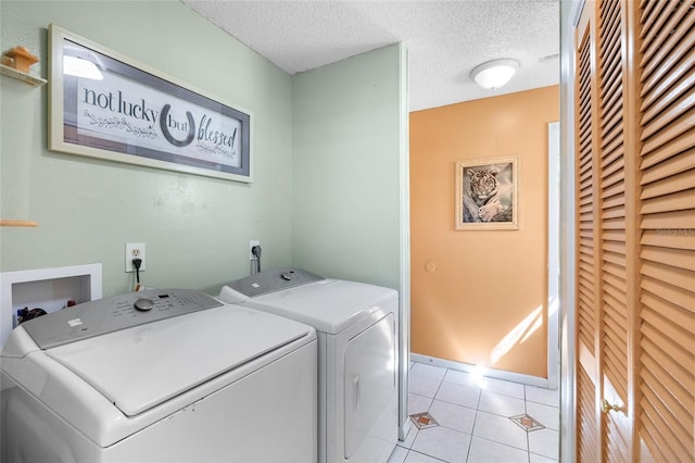 34 Misty Meadow Ln, Mulberry, FL 33860 - laundry room with laundry area, separate washer and dryer, light tile patterned flooring, and a textured ceiling
