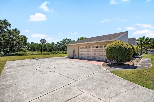 34 Misty Meadow Ln, Mulberry, FL 33860 - view of side of home with a garage, a yard, and stucco siding