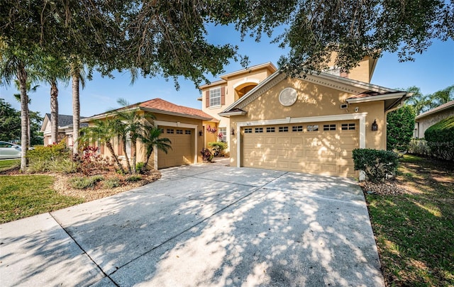 3033 Stonegate Falls Dr, Land O Lakes, FL 34638 - view of front facade featuring an attached garage, stucco siding, and driveway