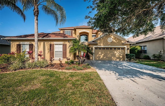3033 Stonegate Falls Dr, Land O Lakes, FL 34638 - mediterranean / spanish house with concrete driveway, stucco siding, a front yard, and a garage