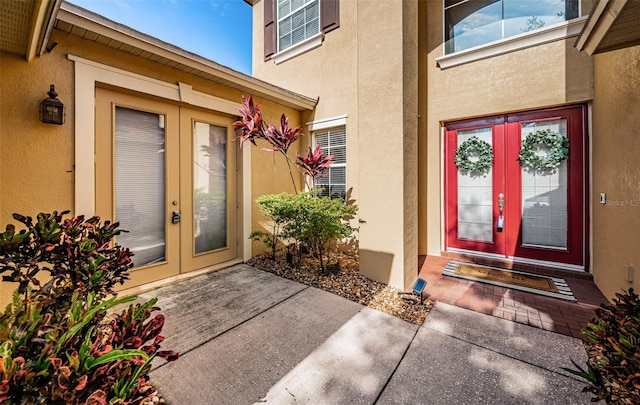 3033 Stonegate Falls Dr, Land O Lakes, FL 34638 - view of exterior entry with stucco siding and french doors