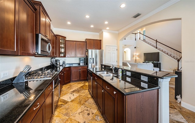 3033 Stonegate Falls Dr, Land O Lakes, FL 34638 - kitchen featuring stone tile flooring, visible vents, a sink, arched walkways, and appliances with stainless steel finishes