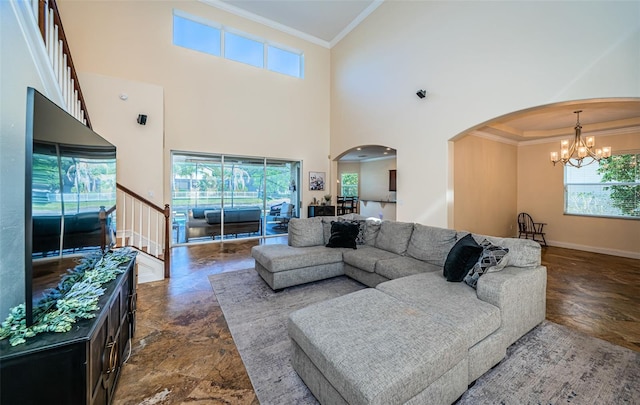 3033 Stonegate Falls Dr, Land O Lakes, FL 34638 - living area featuring stone finish floor, crown molding, plenty of natural light, arched walkways, and a chandelier