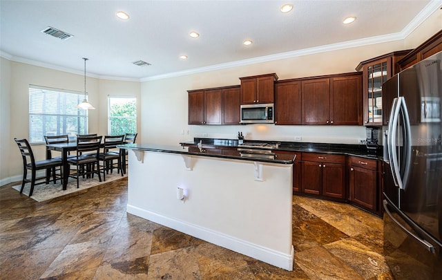 3033 Stonegate Falls Dr, Land O Lakes, FL 34638 - kitchen featuring stainless steel appliances, a kitchen breakfast bar, stone finish floor, visible vents, and baseboards