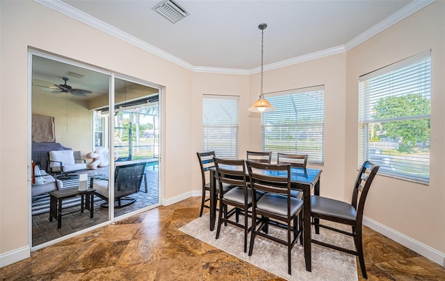 3033 Stonegate Falls Dr, Land O Lakes, FL 34638 - dining room featuring a healthy amount of sunlight, stone finish flooring, crown molding, and visible vents