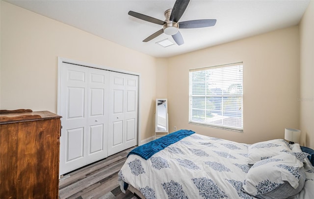 3033 Stonegate Falls Dr, Land O Lakes, FL 34638 - bedroom with a closet, wood finished floors, and ceiling fan