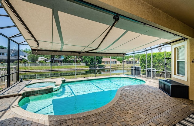 3033 Stonegate Falls Dr, Land O Lakes, FL 34638 - view of swimming pool with a water view, a lanai, a patio, and a pool with connected hot tub