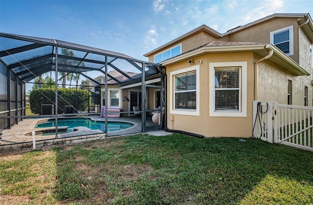 3033 Stonegate Falls Dr, Land O Lakes, FL 34638 - back of property with a lawn, fence, an outdoor pool, a patio area, and stucco siding
