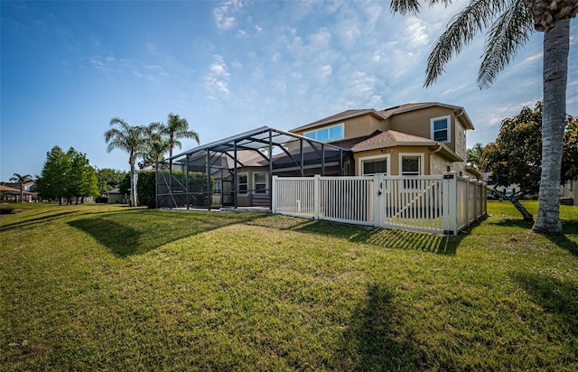 3033 Stonegate Falls Dr, Land O Lakes, FL 34638 - exterior space featuring a yard, stucco siding, fence, and glass enclosure