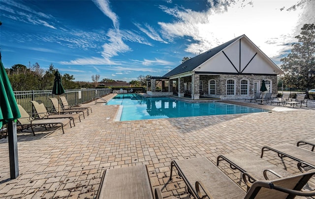 3033 Stonegate Falls Dr, Land O Lakes, FL 34638 - pool featuring a patio area, an outdoor structure, fence, and an exterior structure
