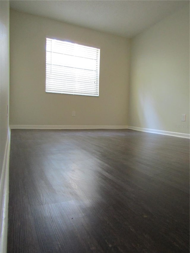 3102 W Horatio St Unit 12, Tampa, FL 33609 - empty room featuring dark wood-style floors and baseboards