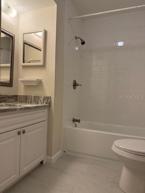 3102 W Horatio St Unit 12, Tampa, FL 33609 - full bath with vanity, toilet, shower / tub combination, and baseboards