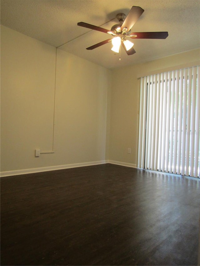 3102 W Horatio St Unit 12, Tampa, FL 33609 - unfurnished room featuring dark wood-type flooring, a ceiling fan, and baseboards