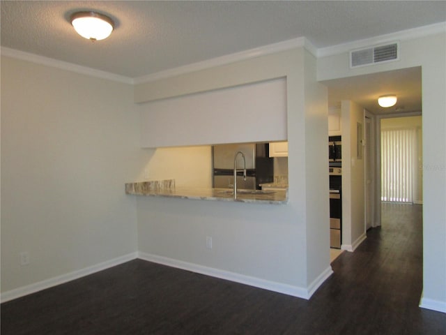 3102 W Horatio St Unit 12, Tampa, FL 33609 - kitchen with ornamental molding, refrigerator, dark wood-style flooring, light countertops, and baseboards