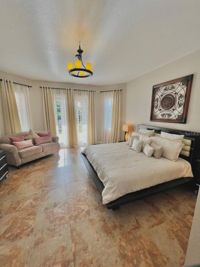 bedroom featuring a textured ceiling and access to exterior