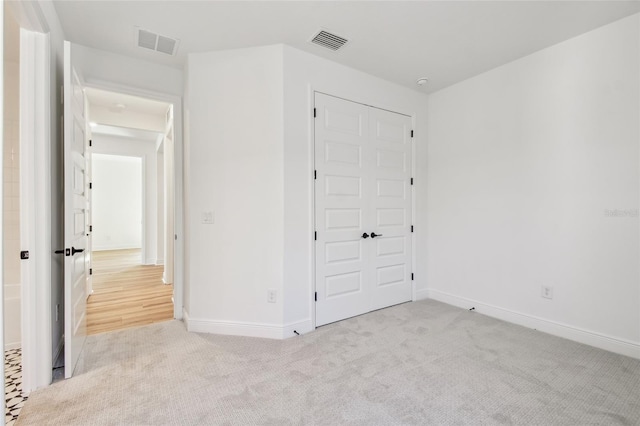 17245 Savory Mist Cir, Bradenton, FL 34211 - unfurnished bedroom featuring baseboards, carpet, a closet, and visible vents