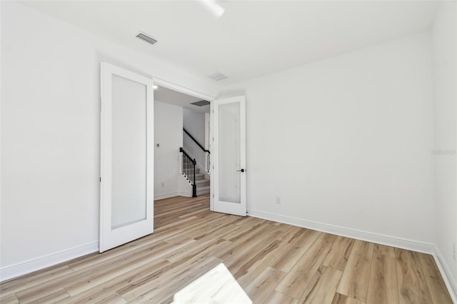 17245 Savory Mist Cir, Bradenton, FL 34211 - spare room featuring baseboards, wood finished floors, and visible vents