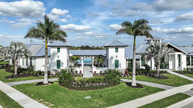 17245 Savory Mist Cir, Bradenton, FL 34211 - view of front facade with a standing seam roof, metal roof, and a front yard
