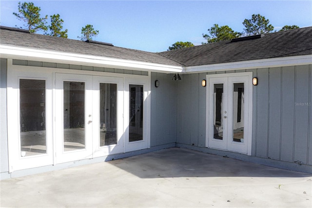3426 Somerset Ave, Deltona, FL 32738 - doorway to property with board and batten siding, french doors, roof with shingles, and a patio