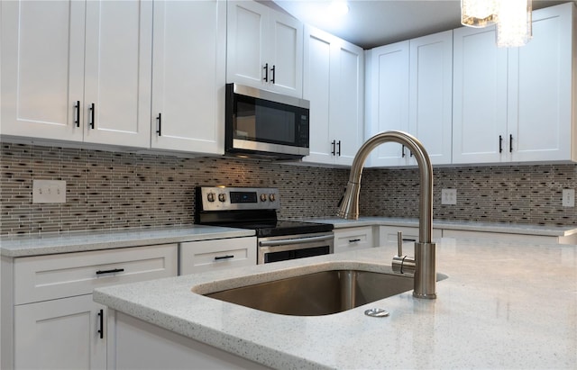 3426 Somerset Ave, Deltona, FL 32738 - kitchen featuring stainless steel appliances, a sink, and white cabinetry