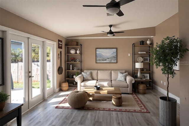 3426 Somerset Ave, Deltona, FL 32738 - living area with vaulted ceiling, visible vents, baseboards, wood finished floors, and ceiling fan