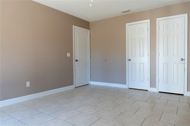 3426 Somerset Ave, Deltona, FL 32738 - unfurnished bedroom with baseboards, visible vents, and light tile patterned floors