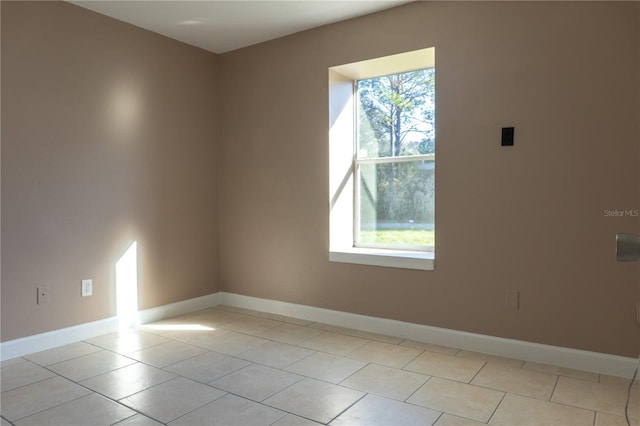 3426 Somerset Ave, Deltona, FL 32738 - unfurnished room featuring light tile patterned floors, baseboards, and plenty of natural light