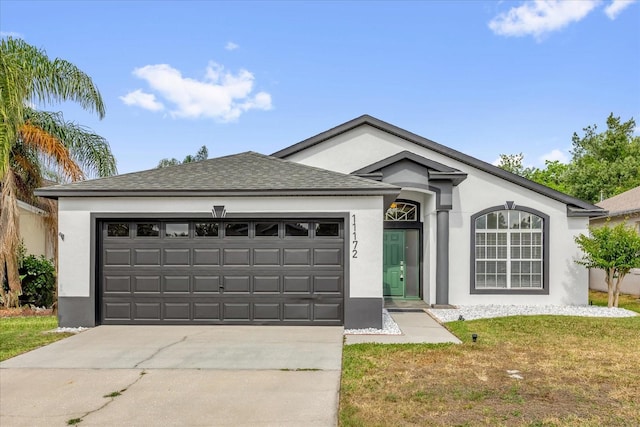 ranch-style home featuring a garage, stucco siding, and driveway