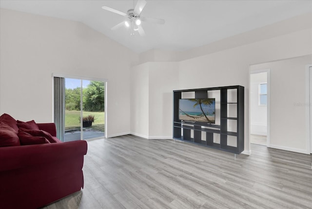 living area featuring baseboards, a ceiling fan, and wood finished floors