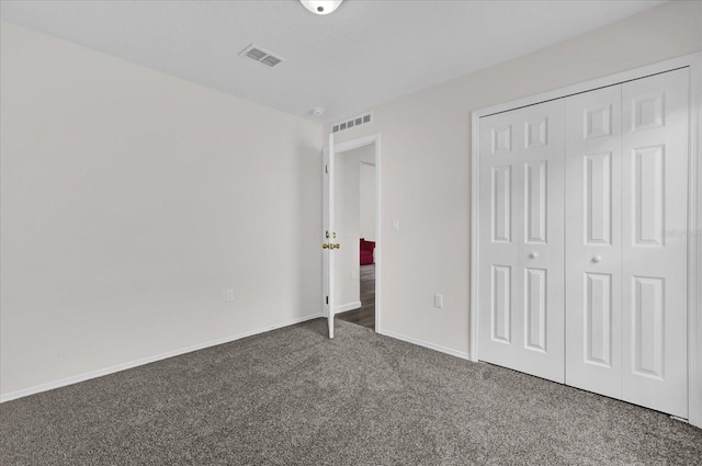 unfurnished bedroom featuring visible vents, carpet flooring, baseboards, and a closet