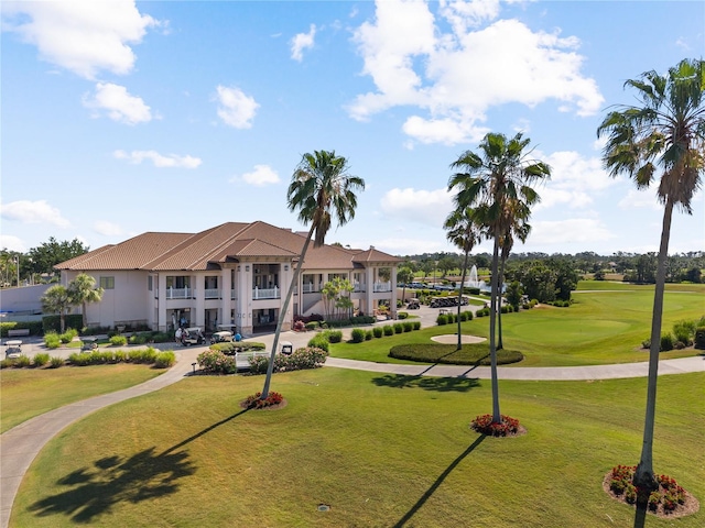 view of property's community with a yard and view of golf course
