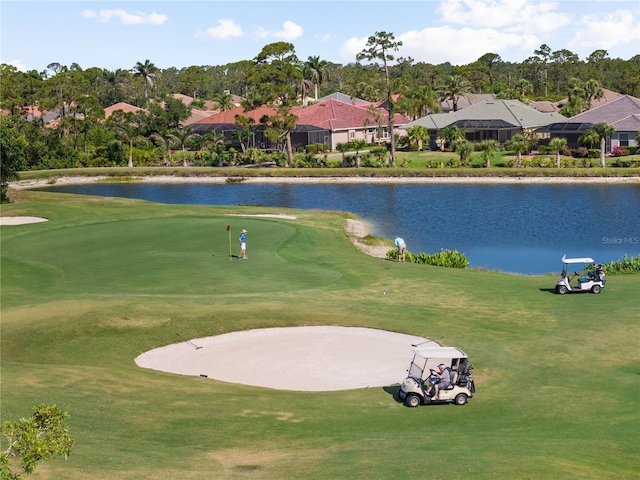 view of home's community with a water view, a residential view, and golf course view
