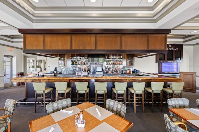 bar with a dry bar, ornamental molding, recessed lighting, and a raised ceiling