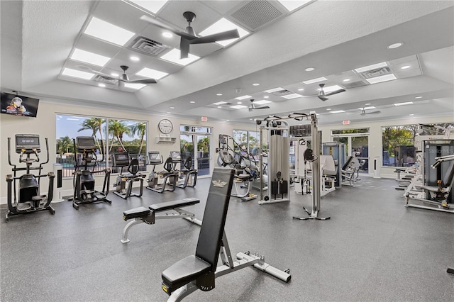 workout area with a raised ceiling, plenty of natural light, and visible vents