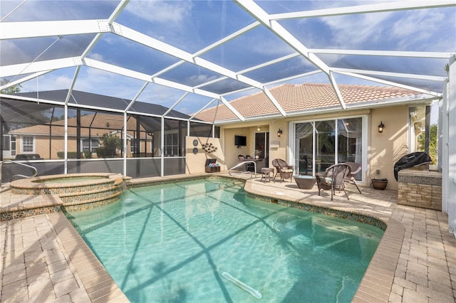 pool featuring a lanai, an in ground hot tub, and a patio area