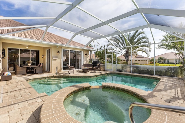 view of pool with a patio, ceiling fan, and a pool with connected hot tub