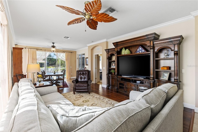 living area with visible vents, a ceiling fan, and crown molding