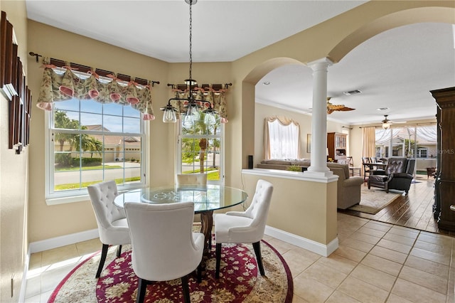 dining space with visible vents, arched walkways, decorative columns, and light tile patterned floors