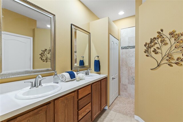 full bathroom featuring double vanity, a sink, and tile patterned flooring