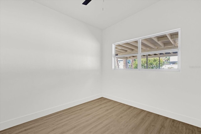 empty room with baseboards, ceiling fan, and wood finished floors