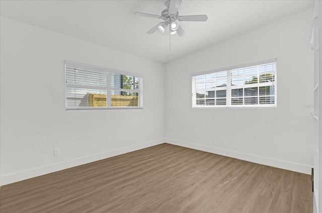 empty room with baseboards, a ceiling fan, and wood finished floors
