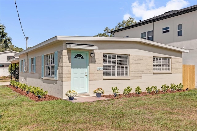view of front of house with fence and a front yard