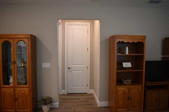 2735 Lavandula Ct, North Port, FL 34289 - doorway to outside with baseboards and wood finished floors