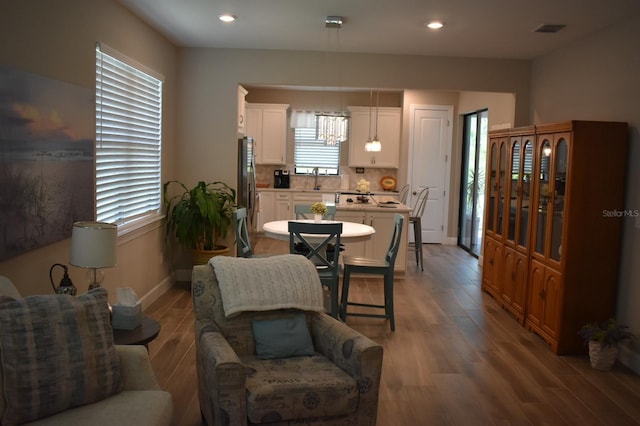 2735 Lavandula Ct, North Port, FL 34289 - dining space featuring a chandelier, recessed lighting, baseboards, wood finished floors, and visible vents