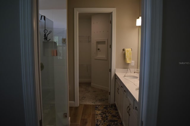 2735 Lavandula Ct, North Port, FL 34289 - bathroom with vanity, a stall shower, and a spacious closet