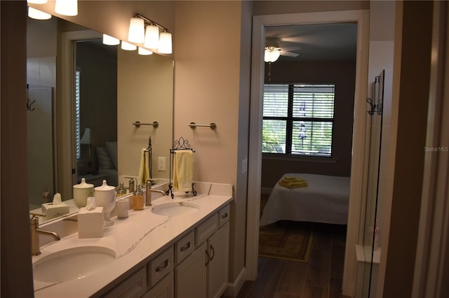 2735 Lavandula Ct, North Port, FL 34289 - ensuite bathroom featuring double vanity, a sink, ceiling fan, and wood finished floors
