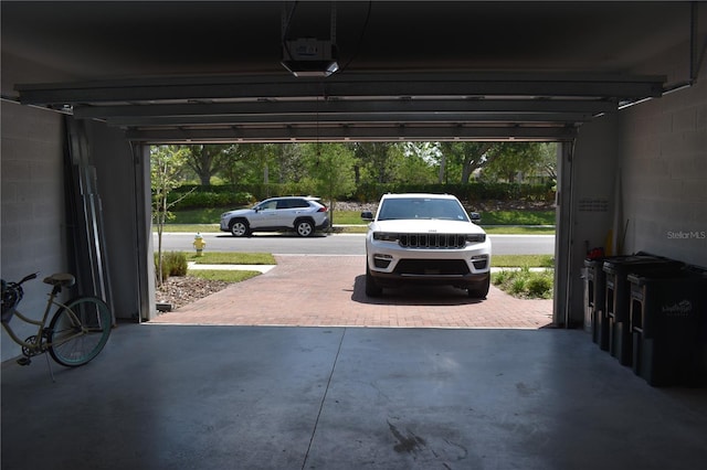 2735 Lavandula Ct, North Port, FL 34289 - garage featuring concrete block wall and a garage door opener