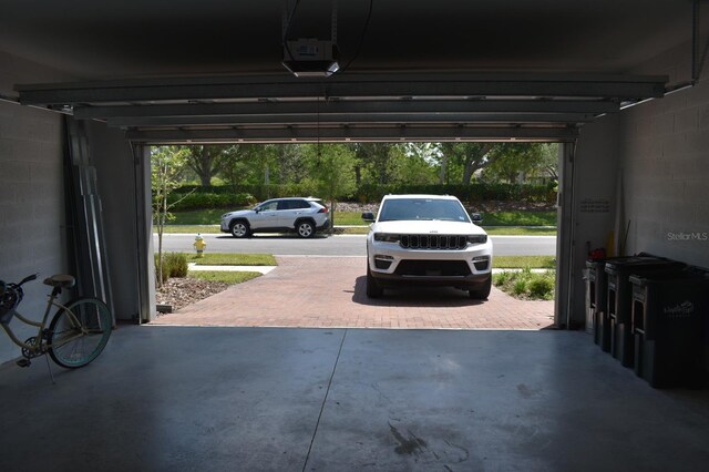 2735 Lavandula Ct, North Port, FL 34289 - garage featuring concrete block wall and a garage door opener